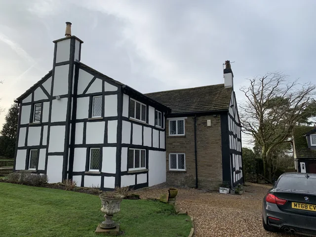 Black-and-white house with stonework in Adlington