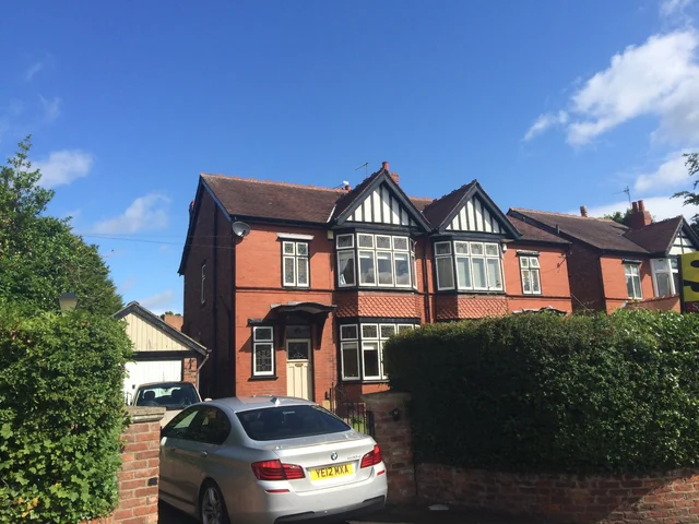 Brick house with timbered gables in Cheadle Hulme