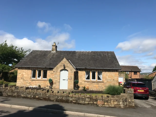 Stone building with an arched entrance in Glossop