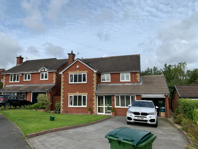 Detached brick house with a front garden in Hazel Grove