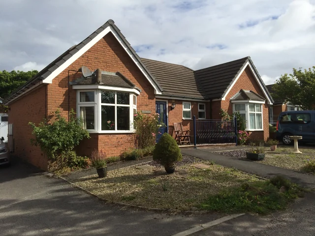 Brick bungalow with projecting gables in New Mills