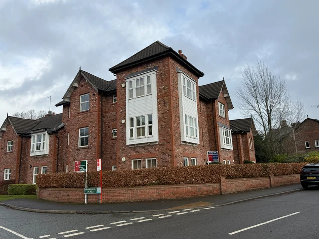 Brick apartment building with projecting windows in Wilmslow