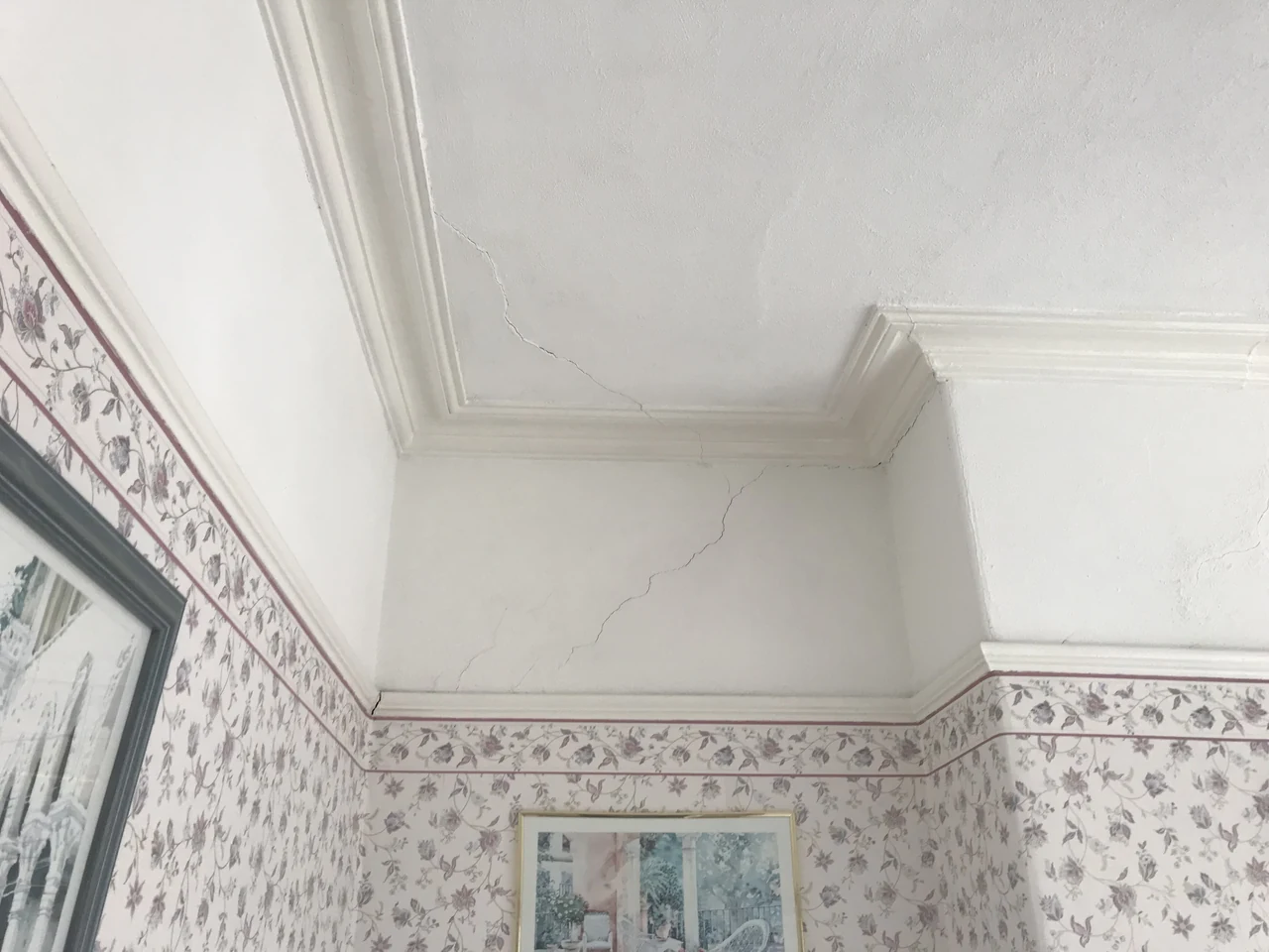 Fracturing to the plaster finish around an upper wall and ceiling junction in Heaton Chapel
