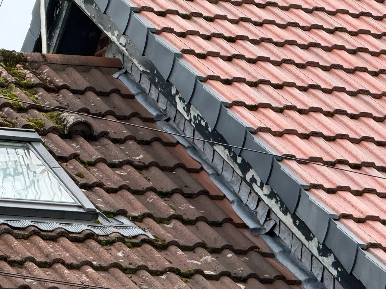 Roof verge projecting over the lower adjoining roof slope in Marple
