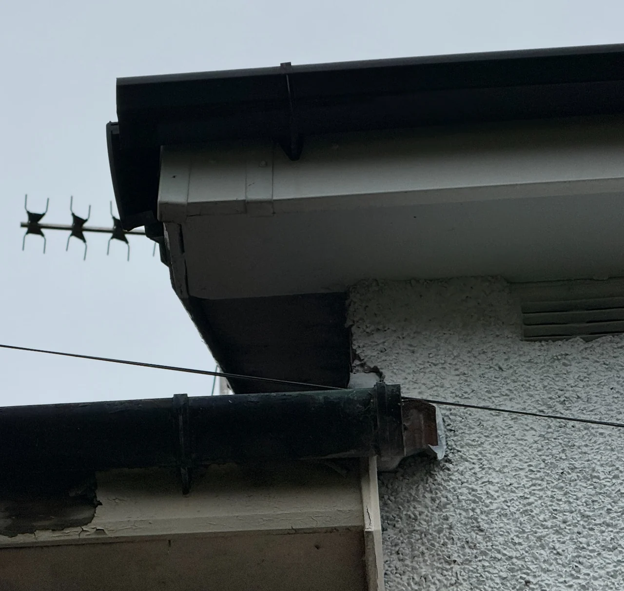 Open gutter end with missing stop end and deteriorated eaves joinery in Marple