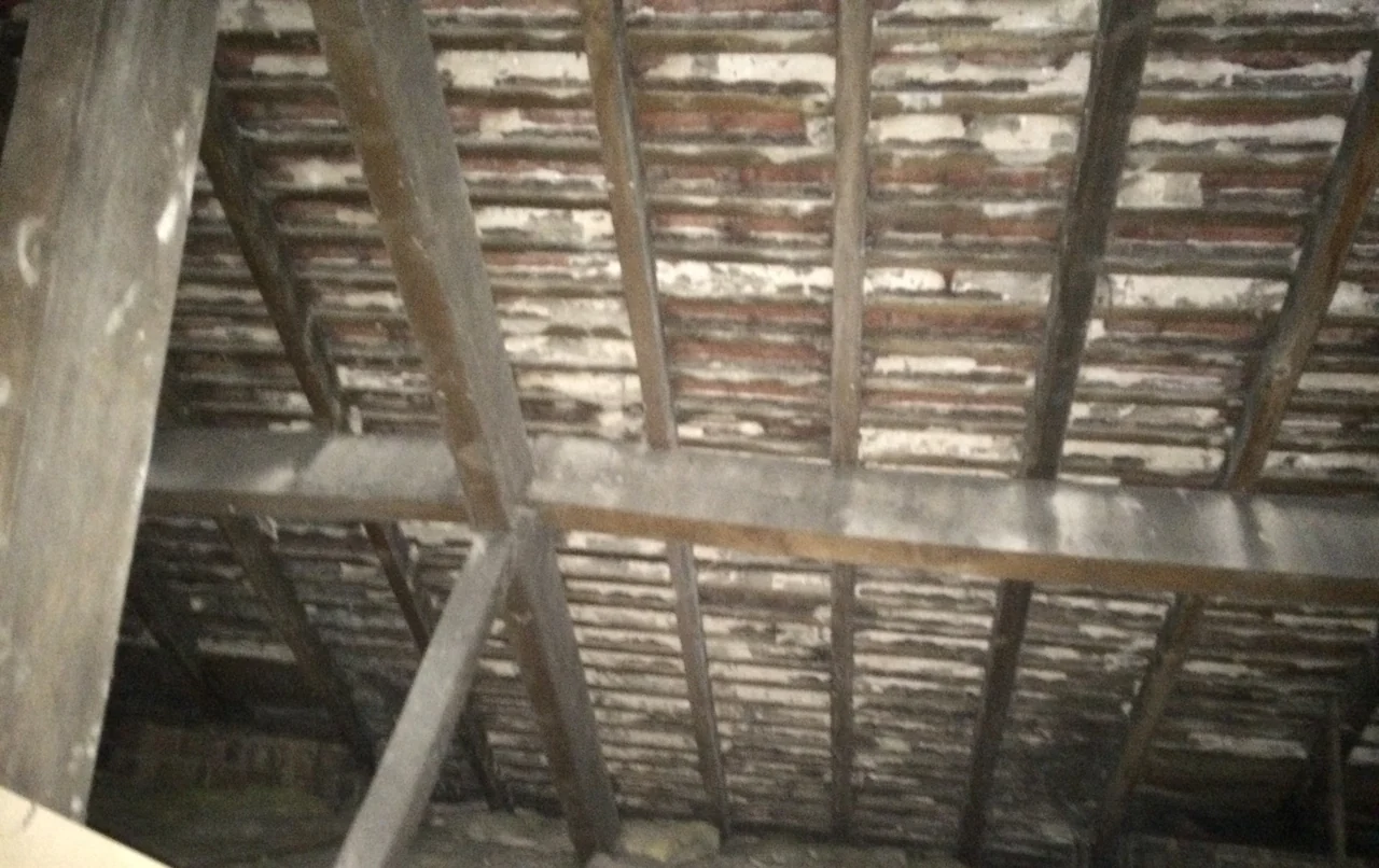Traditional timber roof structure with purlins and rafters in Urmston