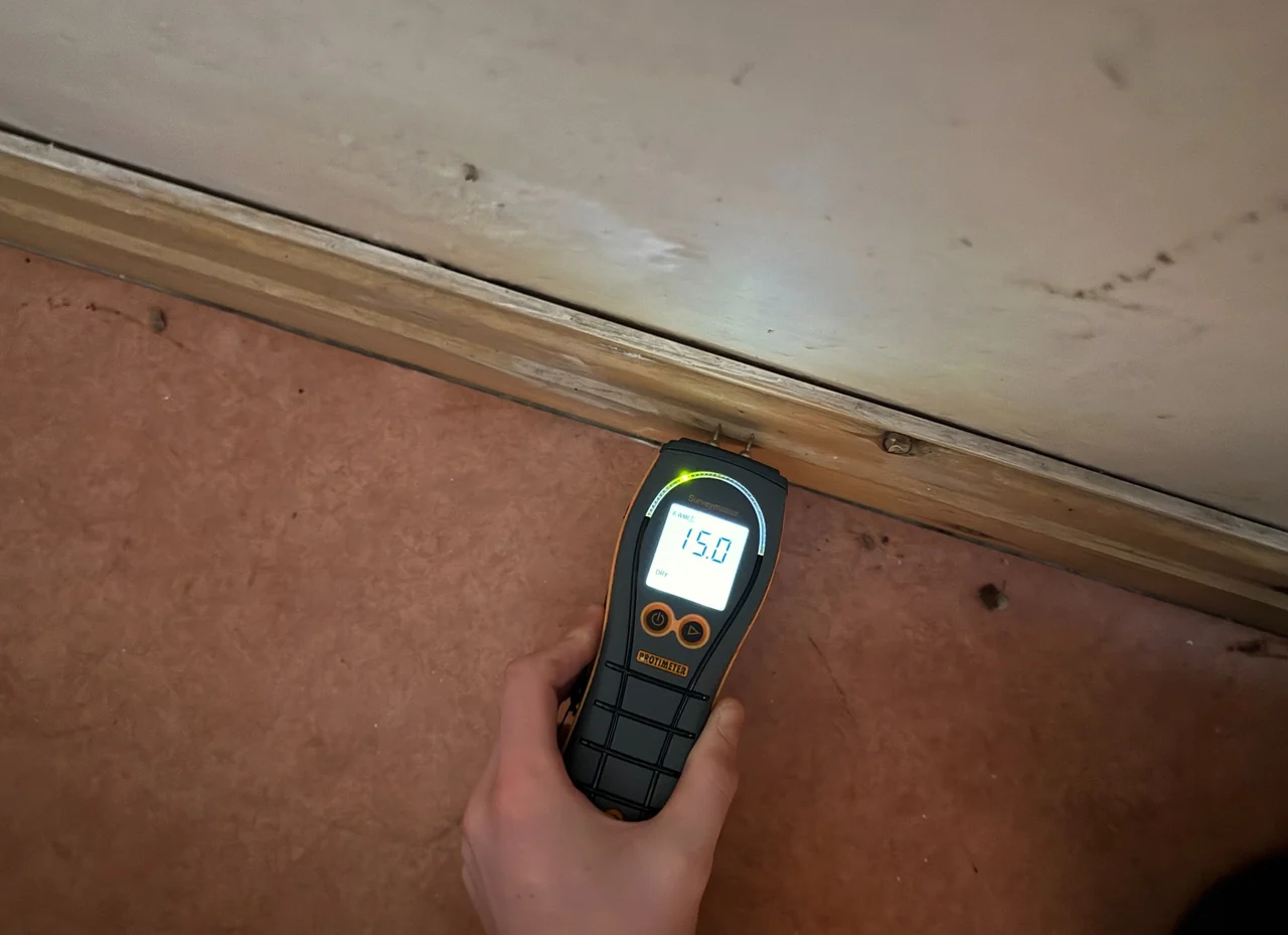 Moisture meter checking timber skirting in Whaley Bridge
