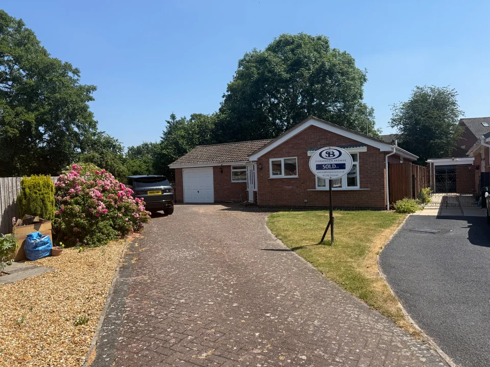 Detached red-brick bungalow with a tiled pitched roof, front garden and driveway