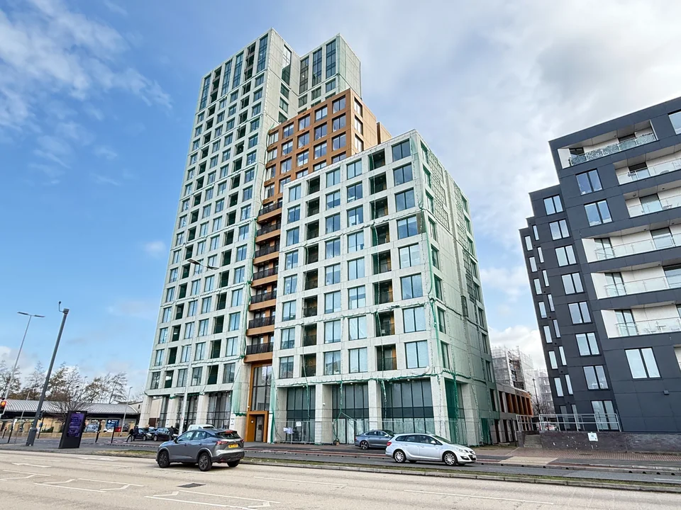 Tall contemporary apartment building with stepped elevations and balconies