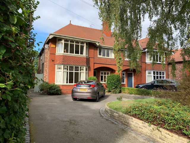 Period brick semi-detached house with bay windows, a tiled roof and front driveway