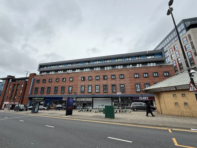 Multi-storey brick building viewed from the adjoining street